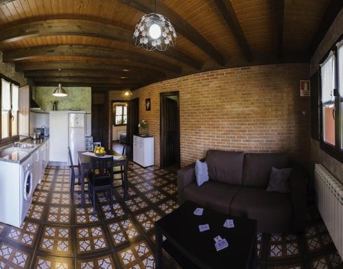 a living room with a couch and a kitchen at Apartamentos Miradorderodiles Mirador in Villaviciosa