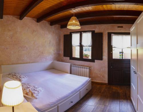 a bedroom with a large bed in a room at Apartamentos Miradorderodiles Mirador in Villaviciosa