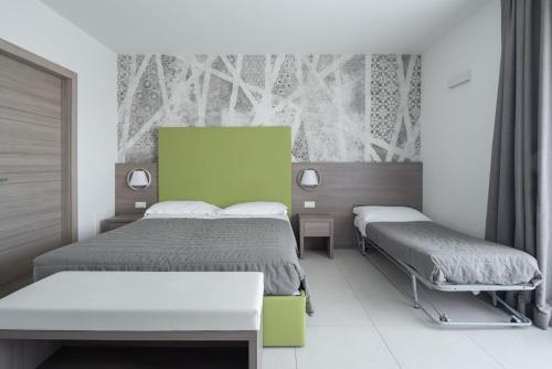 Postel nebo postele na pokoji v ubytování Hotel Iris Jesolo