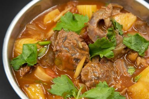a bowl of beef stew with meat and vegetables at Sangthian Beach Resort in Ko Samed
