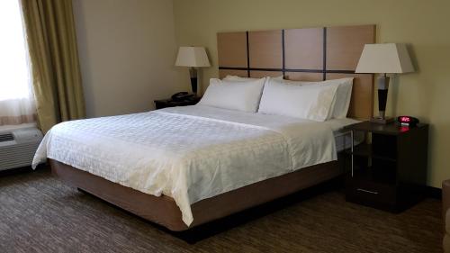 A bed or beds in a room at Candlewood Suites Woodward, an IHG Hotel