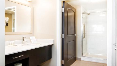 a bathroom with a sink and a shower at Staybridge Suites West Edmonton by IHG in Edmonton