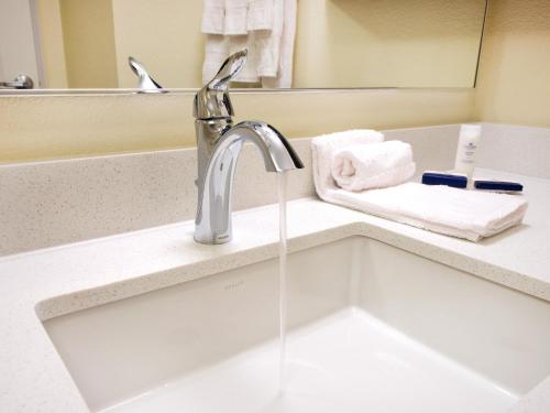 a sink with a faucet in a bathroom at Candlewood Suites Enid, an IHG Hotel in Enid