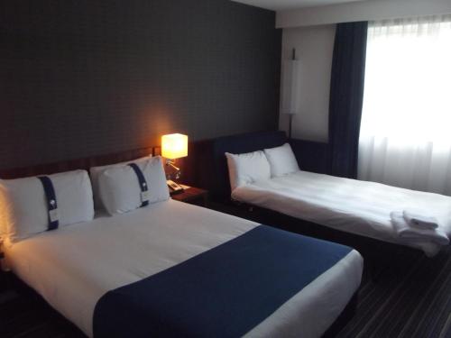 a hotel room with two beds and a window at Holiday Inn Express Preston South by IHG in Preston