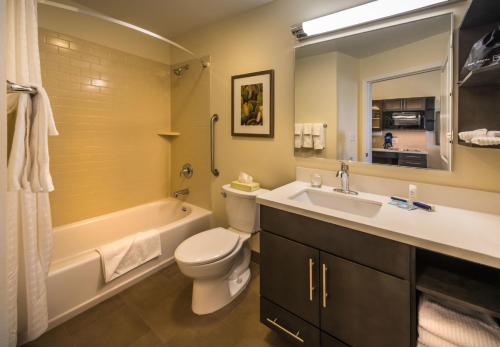 a bathroom with a tub and a toilet and a sink at Candlewood Suites Winnemucca, an IHG Hotel in Winnemucca