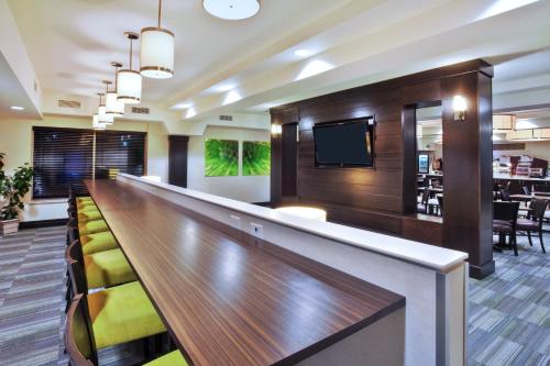 a bar in a hotel lobby with a television at Holiday Inn Express - Sault Ste. Marie by IHG in Sault Ste. Marie