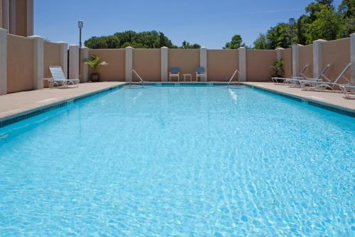 a swimming pool at a hotel with chairs at Holiday Inn Express Washington DC East- Andrews AFB by IHG in Camp Springs