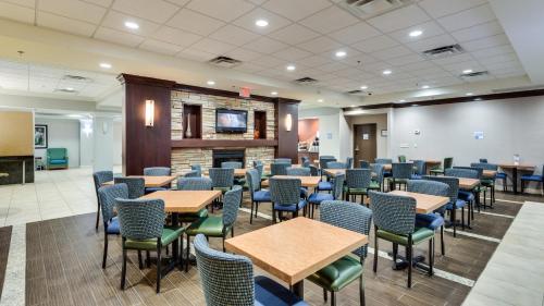 a waiting room with tables and chairs at Holiday Inn Express Washington DC SW - Springfield by IHG in Springfield