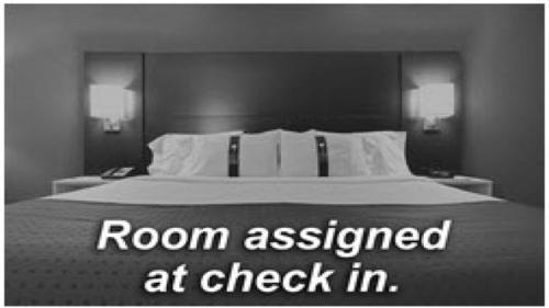 a bedroom with a bed with a room assigned at check in at Holiday Inn Express Brampton by IHG in Brampton