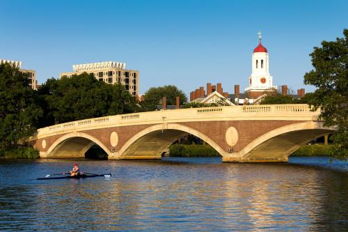 a person in a kayak on the water under a bridge at Holiday Inn Express Boston-Waltham by IHG in Waltham