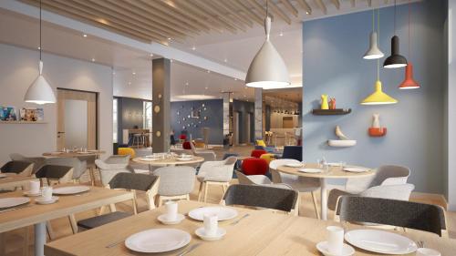 a restaurant with wooden tables and chairs and a cafeteria at Holiday Inn Express Oberhausen by IHG in Oberhausen
