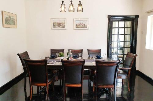 a dining room with a table and chairs at 9Pax BintangCottage CameronHighlands *星之高原屋* in Cameron Highlands