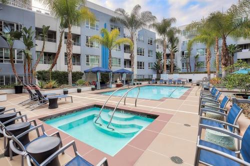 een zwembad met stoelen en een resort bij Central Apartment in Los Angeles