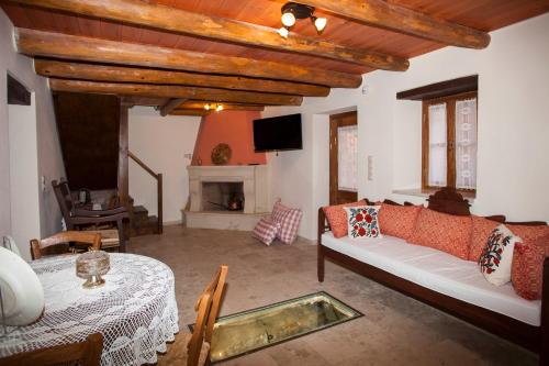 a living room with a couch and a table at Ariadne Traditional Home in Margarítai