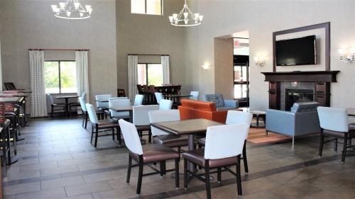 a restaurant with tables and chairs and a fireplace at Holiday Inn Express Hotels & Suites Rockingham West by IHG in Rockingham