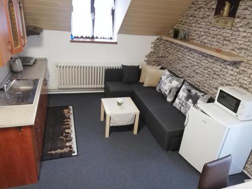 a small living room with a couch and a table at Apartmany Železná Ruda in Železná Ruda