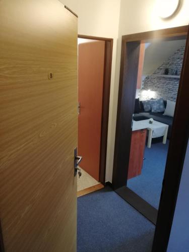 a door leading into a room with a living room at Apartmany Železná Ruda in Železná Ruda