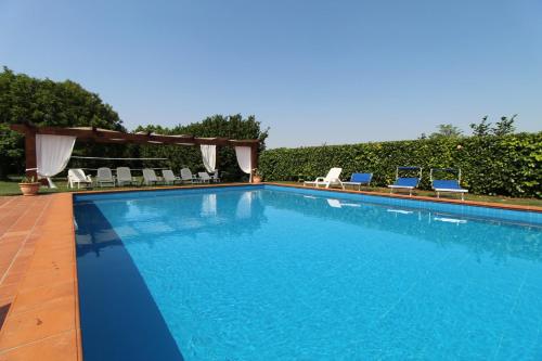 a large swimming pool with chairs at Casale Gelsomino in Rovolon