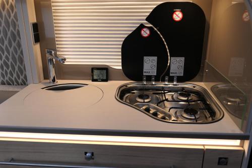 a kitchen counter with a stove and a counter top at Kamping u Łukasza in Zakopane