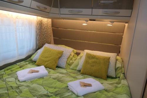 a bedroom with a bed with two towels on it at Kamping u Łukasza in Zakopane