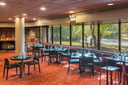 a dining room with tables and chairs and windows at Holiday Inn Express Princeton Southeast by IHG in Plainsboro