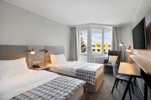 Ένα ή περισσότερα κρεβάτια σε δωμάτιο στο Holiday Inn Munich - South by IHG
