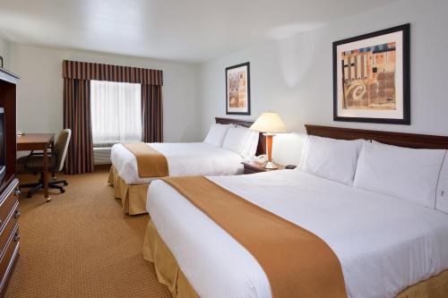 a hotel room with two beds and a desk at Wingate by Wyndham Newell in Newell