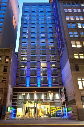 a tall building with blue lights in front of it at Holiday Inn Express - Times Square South by IHG in New York