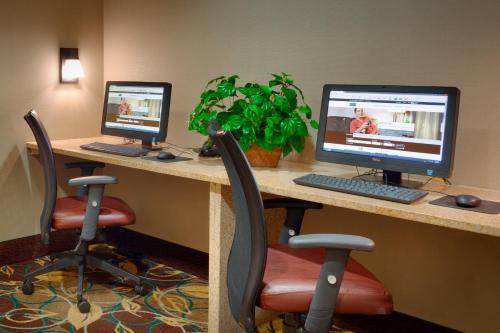 a desk with two computer monitors on top of it at Staybridge Suites Peoria Downtown, an IHG Hotel in Peoria