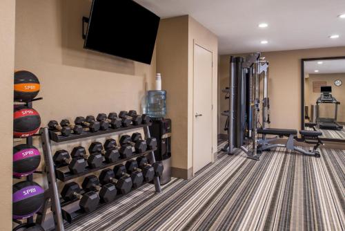 a fitness room with a gym with equipment at Candlewood Suites Kansas City by IHG in Kansas City