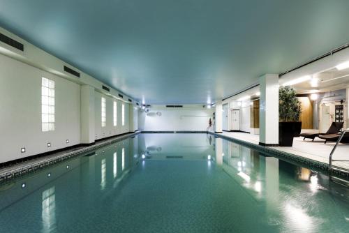 a swimming pool in a large building with at Holiday Inn Milton Keynes Central by IHG in Milton Keynes