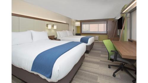 a hotel room with two beds and a desk at Holiday Inn Express & Suites - Olathe South, an IHG Hotel in Olathe