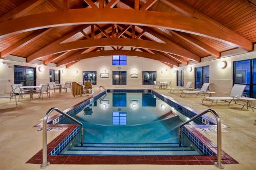 uma grande piscina interior num edifício com tectos em madeira em Staybridge Suites Madison - East, an IHG Hotel em Madison