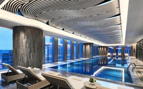 a hotel lobby with a swimming pool and windows at Crowne Plaza Nanning City Center, an IHG Hotel in Nanning