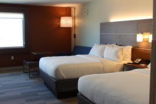 a hotel room with two beds and a window at Holiday Inn Express & Suites Omaha - Millard Area by IHG in Millard