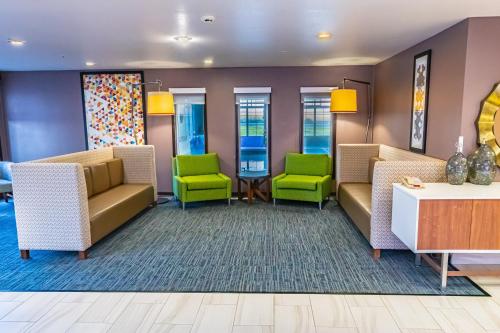 a waiting room with couches and green chairs at Holiday Inn Express Pendleton by IHG in Pendleton