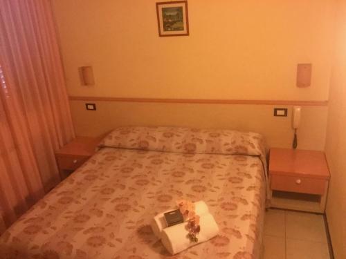 a bedroom with a bed with a box of food on it at Hotel Storyville - svago e convenzioni aziendali in Cinquale