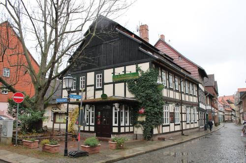 a black and white building on a city street at La Rustica Altstadthotel in Wernigerode