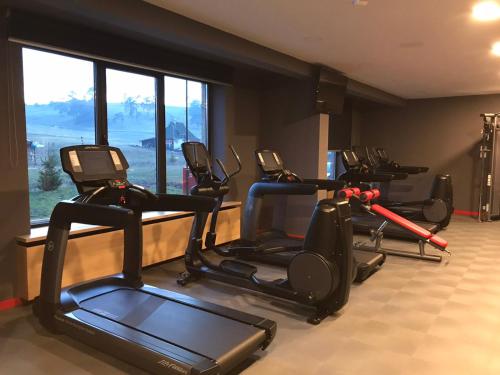 a gym with several exercise bikes in a room at Zlatibor apartman Chill out in Zlatibor