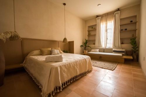 a bedroom with a large bed and a window at Casa Montore by Barrio Mexico in Guadalajara