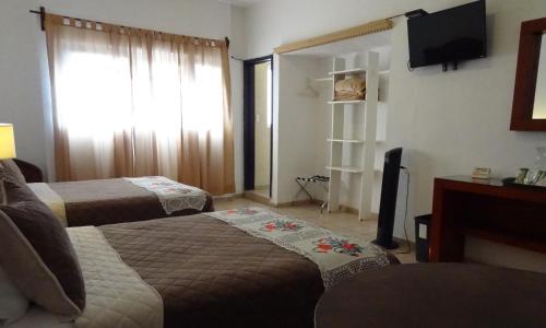 Voodi või voodid majutusasutuse Hotel San Miguel Penjamo toas