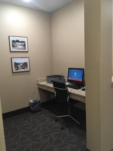 an office with a desk with a computer on it at AmericInn by Wyndham Sioux Falls North in Sioux Falls