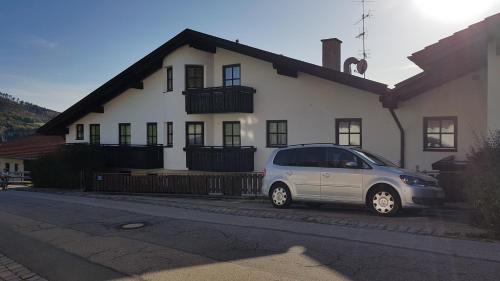 a silver car parked in front of a white house at Appartement Hauzenberg-Panorama in Hauzenberg