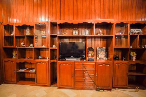 a entertainment center with a television in a room at Casa de Mármol in Riobamba