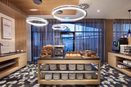 a bakery with a counter with bread on it at Holiday Inn Express - Berlin - Alexanderplatz by IHG in Berlin
