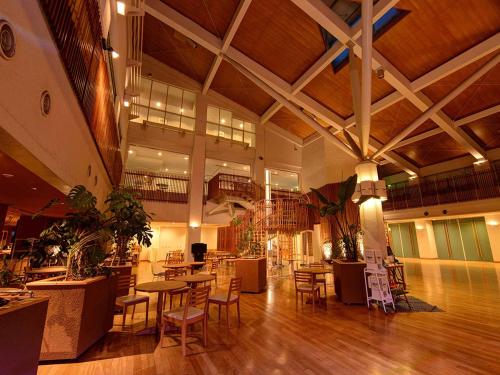 a large room with tables and chairs in a building at The Day Osaka in Osaka