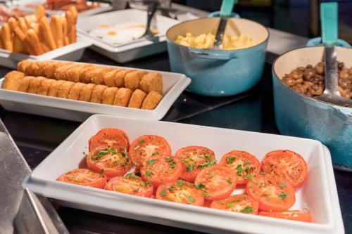 a tray of tomatoes and other food on a table at Holiday Inn Bristol City Centre by IHG in Bristol