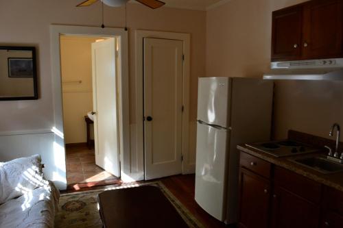 a kitchen with a refrigerator and a door to a hallway at Guerneville Lodge in Guerneville