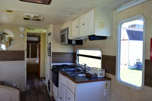 a kitchen in an rv with a sink and a window at Sea Tiger Island Inn Shodoshima in Shodoshima