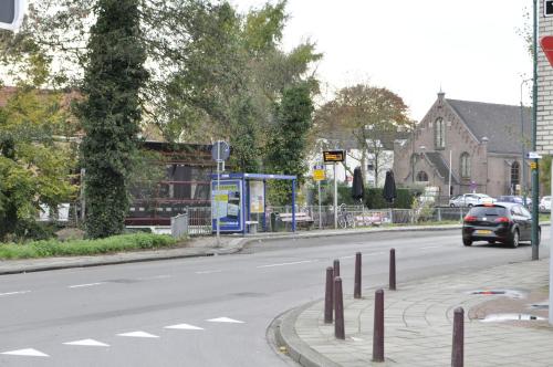 a car is driving down a city street at City Hotel Koningsvlinder in Veenendaal